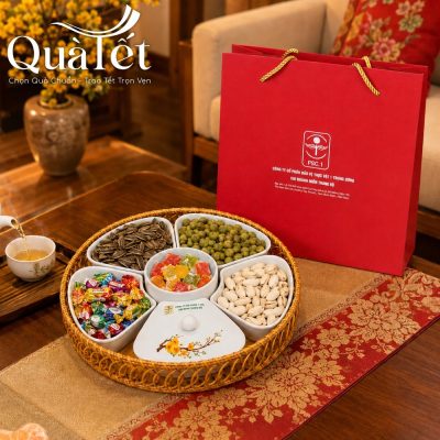 Bộ khay mứt sứ chứa đầy các loại hạt, mứt Tết bày biện đẹp mắt cạnh túi quà đỏ sang trọng