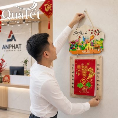 Nhân viên treo mẫu lịch gỗ Welcome to Vietnam tại khu vực sảnh lễ tân